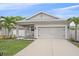 Charming single-story home with a well-manicured lawn, inviting seating area, and a two-car garage at 867 Bacon Ave, Sarasota, FL 34232