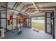 Inside the shed, there's a functional home gym with weights, bench, and a clear view of the backyard at 867 Bacon Ave, Sarasota, FL 34232