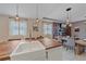 Modern open-concept kitchen with a spacious island, farmhouse sink, and stylish lighting, flowing into the dining area at 867 Bacon Ave, Sarasota, FL 34232