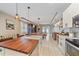 Stylish kitchen with wood island, stainless appliances, open to the dining area and living room at 867 Bacon Ave, Sarasota, FL 34232