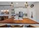 Modern kitchen with a large wood island, white cabinets, and stylish pendant lighting at 867 Bacon Ave, Sarasota, FL 34232