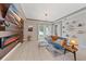 Living room with accent wall, decorative fireplace, and sliding glass door at 867 Bacon Ave, Sarasota, FL 34232