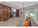 Living room featuring wood paneling, a decorative fireplace, and a sliding glass door at 867 Bacon Ave, Sarasota, FL 34232