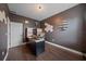 Office featuring wood floors, a dark accent wall, hexagon decorations and a built-in desk with shelving at 867 Bacon Ave, Sarasota, FL 34232