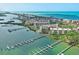 Picturesque aerial of waterfront community with docks, boats, and manicured grounds at 8701 Midnight Pass Rd # 206A, Sarasota, FL 34242
