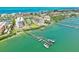 Breathtaking aerial view of waterfront condos, docks, and lush landscaping at 8701 Midnight Pass Rd # 206A, Sarasota, FL 34242