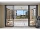 Enjoy the outdoors on this private glass enclosed balcony with chairs and great views at 8701 Midnight Pass Rd # 206A, Sarasota, FL 34242
