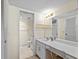 Well-lit bathroom boasts a vanity with ample counter space, vanity lighting, and tiled floors at 8701 Midnight Pass Rd # 206A, Sarasota, FL 34242