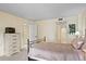 Comfortable bedroom features a neutral color palette, a dresser, and an adjoining bathroom at 8701 Midnight Pass Rd # 206A, Sarasota, FL 34242