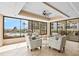 Bright clubhouse sitting area with large windows overlooking pool and tropical landscaping at 8701 Midnight Pass Rd # 206A, Sarasota, FL 34242