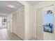 Condo hallway with multiple storage closets and easy access to the bar and other living areas at 8701 Midnight Pass Rd # 206A, Sarasota, FL 34242