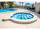 Relaxing community hot tub with custom tiling and tropical landscaping at 8701 Midnight Pass Rd # 206A, Sarasota, FL 34242
