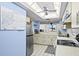 Bright kitchen with white appliances and tile floors with plenty of counter space for cooking at 8701 Midnight Pass Rd # 206A, Sarasota, FL 34242