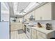 Bright kitchen with white appliances, tile floors, plenty of counter space, and updated lighting at 8701 Midnight Pass Rd # 206A, Sarasota, FL 34242