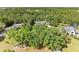 An aerial view of a lush, tree-filled neighborhood with a house nestled among the trees at 906 134Th E St, Bradenton, FL 34212