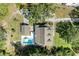 Aerial view of home showcasing its large lot, in-ground pool, and mature trees at 906 134Th E St, Bradenton, FL 34212