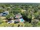 An aerial view of a property with a pool, lush greenery, and proximity to a lake at 906 134Th E St, Bradenton, FL 34212