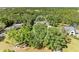 An aerial view of a lush, tree-filled neighborhood with a house nestled among the trees at 906 134Th E St, Bradenton, FL 34212