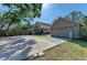 Spacious backyard featuring a detached garage and large driveway at 906 134Th E St, Bradenton, FL 34212
