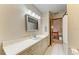 Well-lit bathroom features a large vanity and a neutral color palette at 906 134Th E St, Bradenton, FL 34212