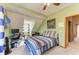 Comfortable bedroom featuring a striped comforter, desk, and bright natural light at 906 134Th E St, Bradenton, FL 34212