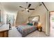 A bedroom with a modern ceiling fan, ample light, and a tranquil vibe at 906 134Th E St, Bradenton, FL 34212