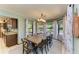 Elegant dining room with a large table, chandelier, and multiple windows at 906 134Th E St, Bradenton, FL 34212