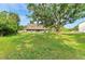 Captivating exterior view showcasing a two-story home with a sprawling lawn and mature trees at 906 134Th E St, Bradenton, FL 34212