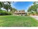 Charming exterior elevation of a two-story home with a spacious porch and well-manicured lawn at 906 134Th E St, Bradenton, FL 34212