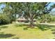 A picturesque home with mature trees and a large front yard, offering a tranquil setting at 906 134Th E St, Bradenton, FL 34212