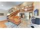 Spacious living room with wooden staircase and hardwood floors at 906 134Th E St, Bradenton, FL 34212