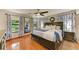 Spacious main bedroom with wood floors, ceiling fan, and large windows offering lots of natural light at 906 134Th E St, Bradenton, FL 34212