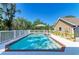 Beautiful backyard pool area with white fencing and lush landscaping at 906 134Th E St, Bradenton, FL 34212