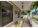 Cozy porch featuring potted plants, hanging ferns, and wooden decking at 906 134Th E St, Bradenton, FL 34212