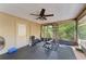 Workout area with ceiling fan, screened windows, door, and weights for convenient and private exercise at 906 134Th E St, Bradenton, FL 34212
