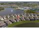 Aerial view showcasing the single Gathering home's location near the community pool and lake at 8752 Coastal Key Way, Parrish, FL 34219