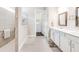 Modern bathroom featuring a walk-in shower, dual vanities, and sleek finishes for a luxurious and comfortable experience at 8752 Coastal Key Way, Parrish, FL 34219