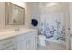 Bathroom with modern vanity, mirror and a shower featuring a stylish blue and white curtain at 8752 Coastal Key Way, Parrish, FL 34219
