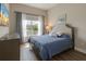 Comfortable bedroom featuring a cozy bed, dresser, a bright window, and a soothing color palette at 8752 Coastal Key Way, Parrish, FL 34219