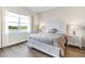 Serene bedroom boasts natural light, complemented by neutral tones, creating a relaxing atmosphere with scenic views at 8752 Coastal Key Way, Parrish, FL 34219