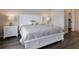 Bright bedroom boasts a serene ambiance with a beautiful bed frame, stylish bedside tables, and a walk-in closet at 8752 Coastal Key Way, Parrish, FL 34219