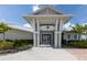 Sailfish Grille clubhouse entrance featuring modern architectural details and lush landscaping at 8752 Coastal Key Way, Parrish, FL 34219
