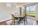 Cozy dining area with a stylish table and chairs, complemented by scenic views through sliding glass doors at 8752 Coastal Key Way, Parrish, FL 34219