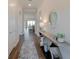 Hallway featuring modern floors and bright interior doors with views to the living room at 8752 Coastal Key Way, Parrish, FL 34219