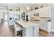 Modern kitchen featuring stainless steel appliances, a large center island with bar seating, and ample cabinet space at 8752 Coastal Key Way, Parrish, FL 34219
