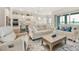 Open-concept living room featuring sleek floors, comfortable seating, and an eat-in kitchen at 8752 Coastal Key Way, Parrish, FL 34219