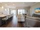 Open-concept living room boasts sleek floors, comfortable seating, and abundant natural light at 8752 Coastal Key Way, Parrish, FL 34219