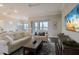Bright living room featuring comfortable seating, sleek floors, and a wall-mounted television at 8752 Coastal Key Way, Parrish, FL 34219