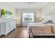 Bright and spacious bedroom with a large window, featuring a calming color scheme, and hardwood floors at 8752 Coastal Key Way, Parrish, FL 34219