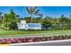 Welcoming entrance to Tideline community with beautiful landscaping, flowers and a signature sign, offering curb appeal at 1019 Tideline Cv, Bradenton, FL 34209
